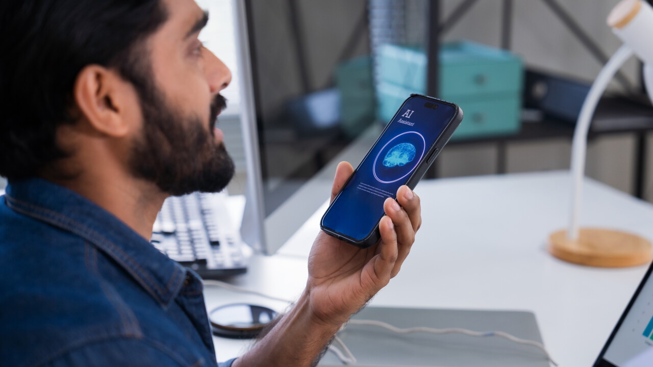 Man speaking into phone, using AI