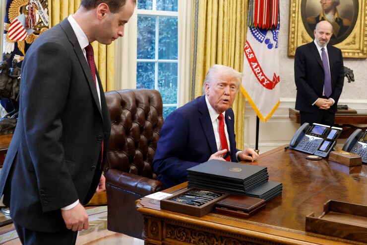 President Donald Trump at his desk in the Oval Office