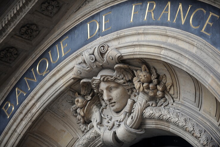 A relief by sculptor Albert Carrier-Belleuse hangs over the entrance to the Banque de France in Paris.