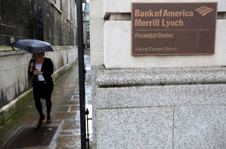 A pedestrian shelters from the rain beneath an umbrella as she walks past the King Edward Street entrance to the Bank of America Merrill Lynch Financial Centre in London, U.K., on Thursday, Oct. 9, 2014. Norway's sovereign wealth fund Norges Bank Investment Management, the world's largest, agreed to buy the Bank of America Merrill Lynch Financial Centre in London for 582.5 million pounds ($944 million) as it expands its bet on the U.K. capital. Photographer: Chris Ratcliffe/Bloomberg