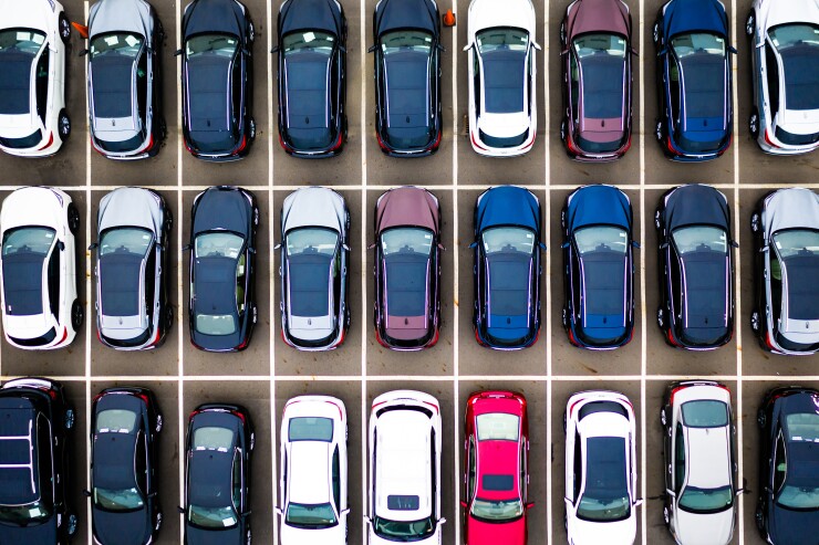 A grid of multicolor cars in a parking lot