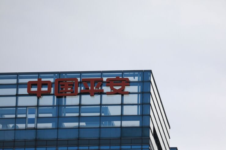 Signage for Ping An Insurance Group Co. is displayed atop a building in Beijing, China, on Thursday, March 14, 2019. China is planning to approve new rules for foreign investment in the country this week, a sweeping overhaul of regulations that will affect corporate titans from Ford to Alibaba and Tencent. Photographer: Giulia Marchi/Bloomberg