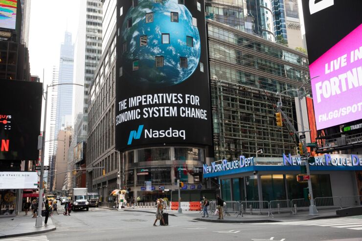 Signage hangs on display outside the Nasdaq MarketSite in the Times Square neighborhood of New York on Sept. 14, 2020
