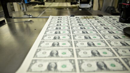 Stacks of 2017 50 subject uncut sheets of $1 dollar notes bearing the name of U.S. Treasury Secretary Steven Mnuchin sit in a machine at the U.S. Bureau of Engraving and Printing in Washington, D.C., U.S., on Wednesday, Nov. 15, 2017.