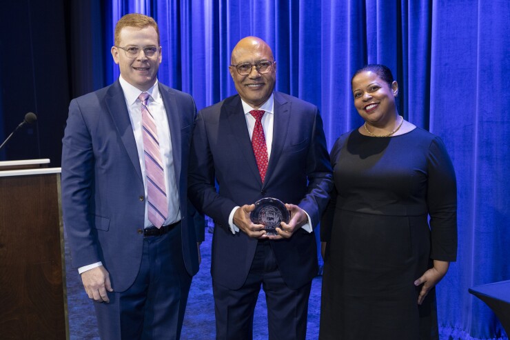 Michael Britchkow, Jacques Jiha and Tara Boirard onstage at the Municipal Forum of New York's awards dinner.