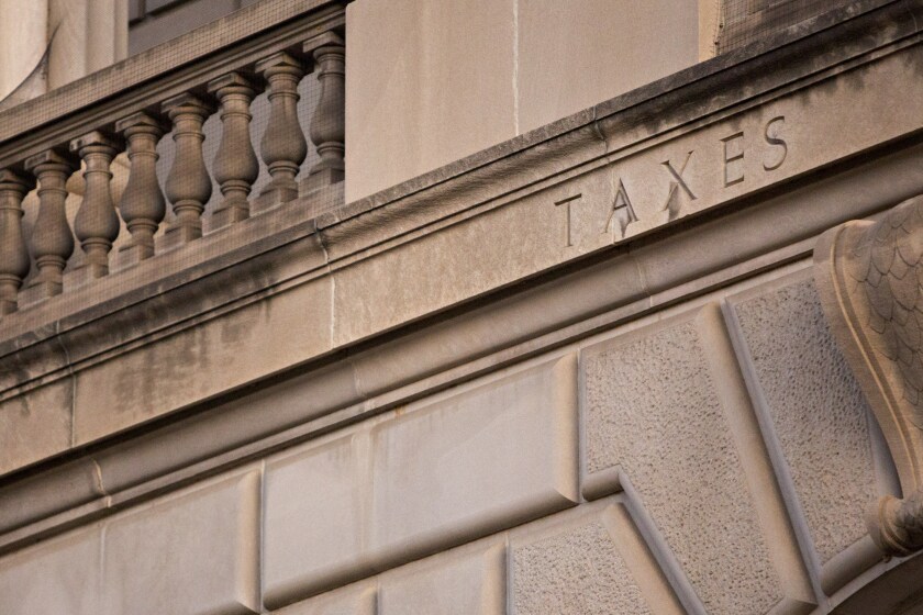 The word "Taxes" is seen on the facade of the Internal Revenue Service headquarters in Washington, D.C.