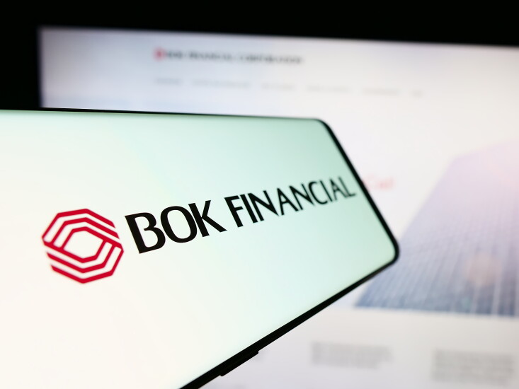 Stuttgart, Germany - 12-23-2023: Smartphone with logo of American financial services company BOK Financial Corporation in front of website. Focus on center-left of phone display.
