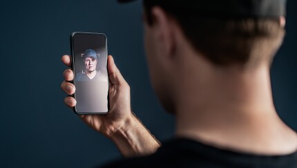 Face recognition with facial scan in phone. Identification and verification to unlock smartphone. Deep fake technology. Man using cellphone. AI mobile tech and biometric id authentication. Data access