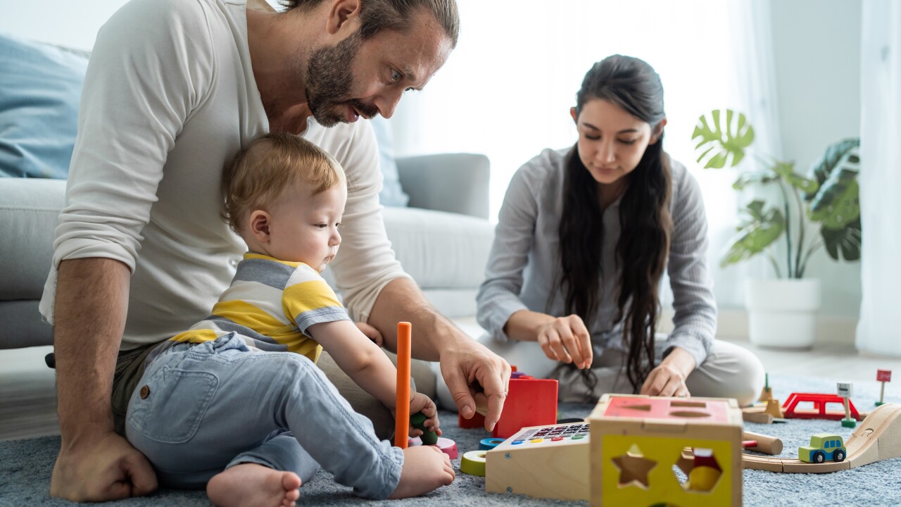 Family playing on the floor with a small child