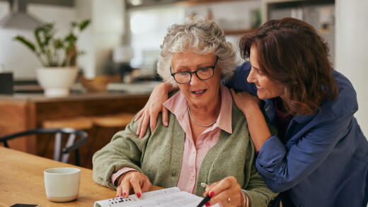 Woman hugging shoulders of mom, smiling