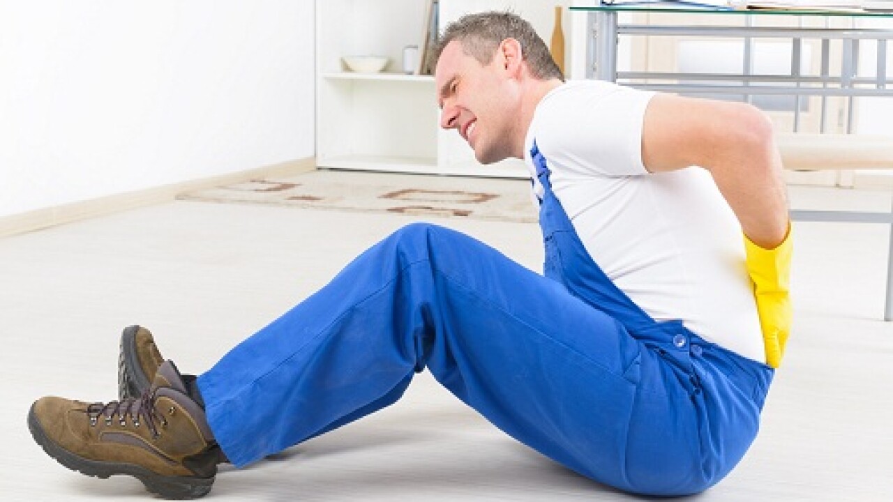 Worker with back injury, concept of accident at work