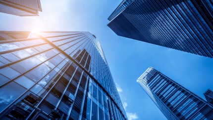 Reflective buildings against a blue sky