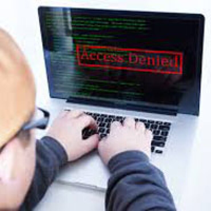 Someone looks at a laptop that reads access denied.