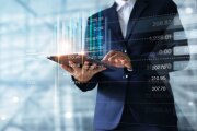 Businessman using tablet analyzing data.