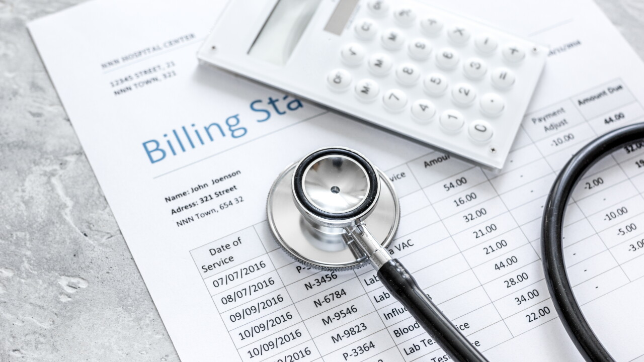 Medical billing statement, stethoscope and calculator