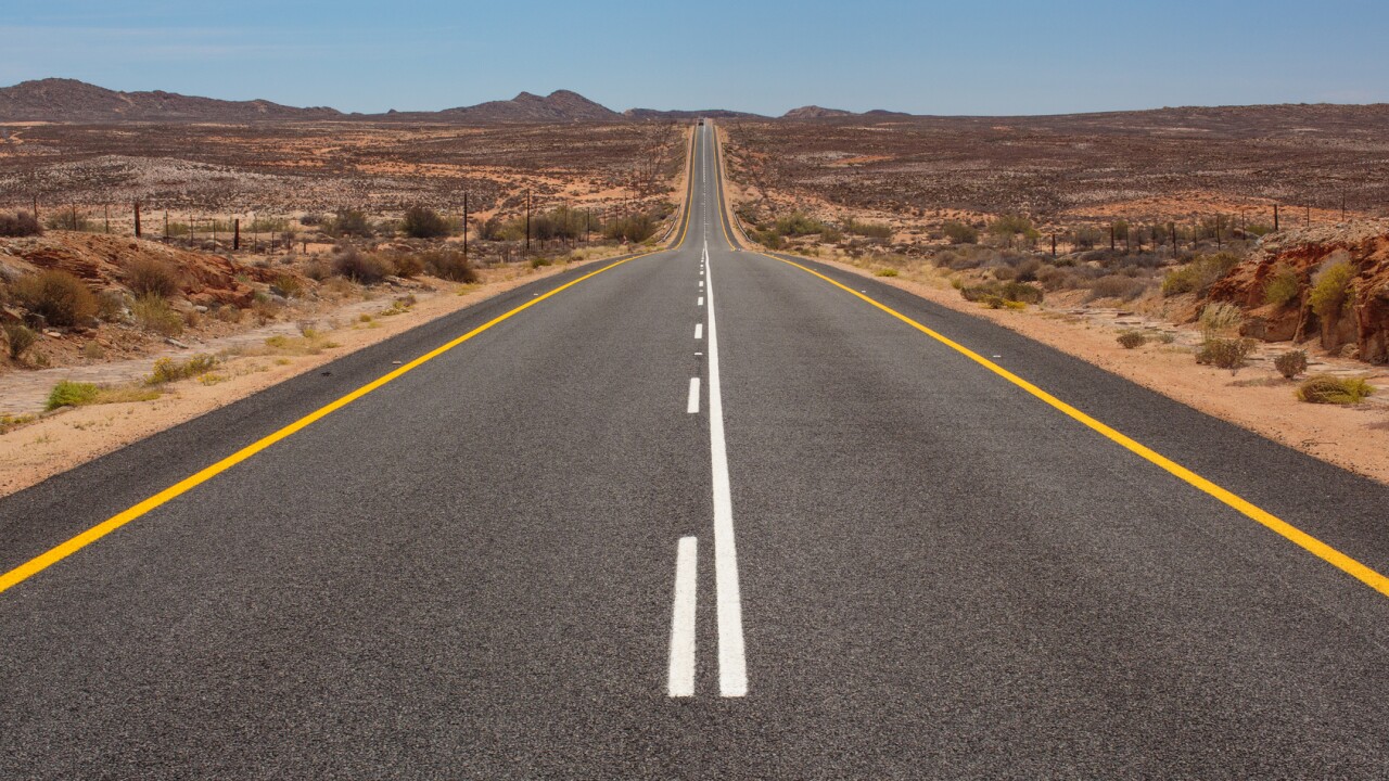 A two-way stretch of road that goes into the distance