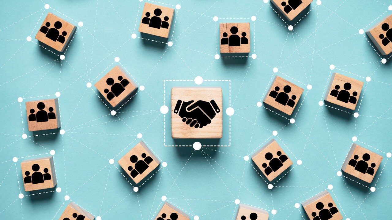 Hand shaking icon print screen on wooden block cube and linkage with people icon for corporate and business deal agreement concept.