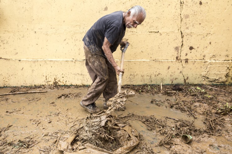 A resident shovels debris after Hurricane Maria in Arecibo, Puerto Rico.