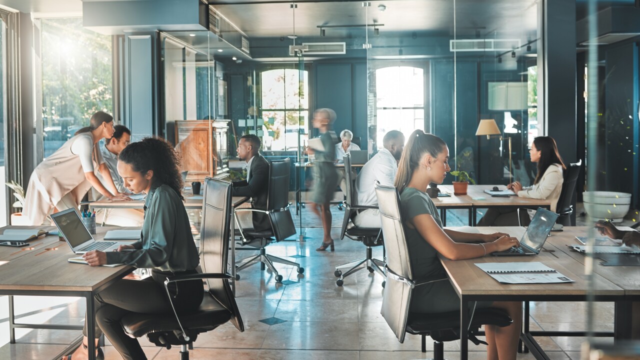 A modern office with workers at their desks.