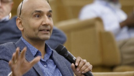 Surjit Chana holding a microphone