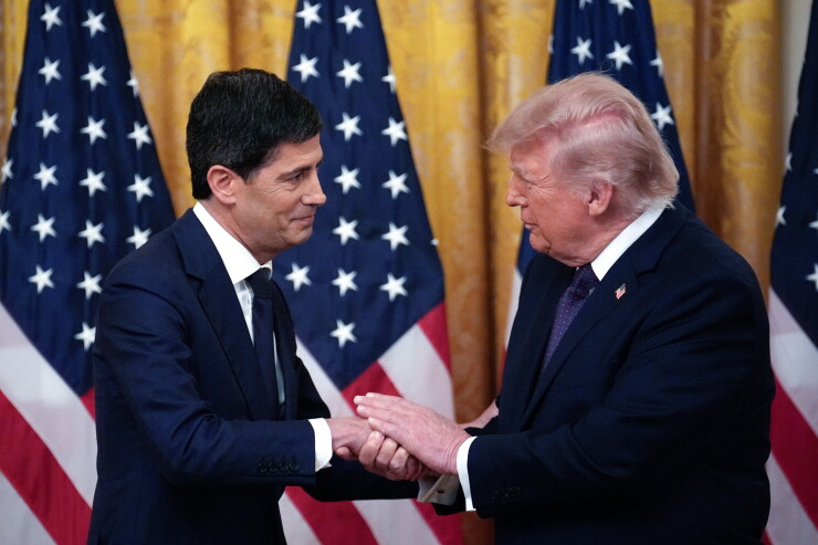 President Donald Trump and Kevin Warsh, chairman of the Federal Reserve, shake hands