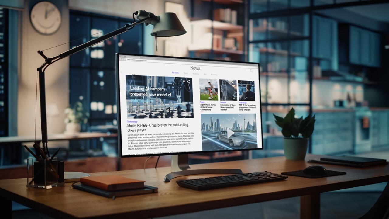 Computer screen on a desk with a message about AI on it.