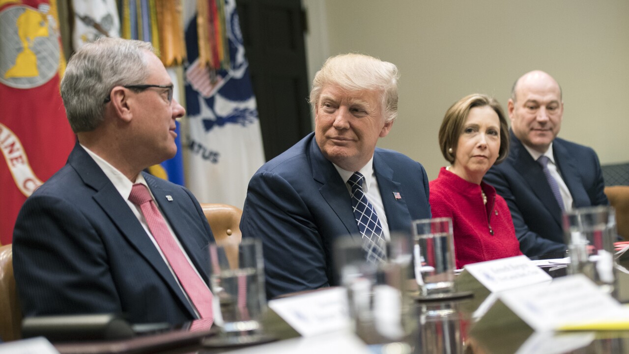Kenneth Burgess, chairman of the First Capital Bank of Texas, from left, speaks while President Trump, Dorothy Savarese, CEO of the Cape Cod Five Cents Savings Bank, and Gary Cohn, director of the U.S. National Economic Council, listen.