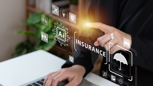 A person typing with a holographic image that reads AI and insurance.