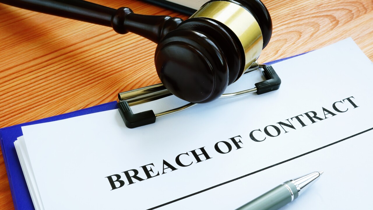 Breach of contract papers with pen and gavel.