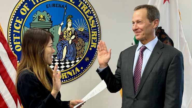 California State Treasurer Fiona Ma swears Deputy Treasurer John Sheldon into office.
