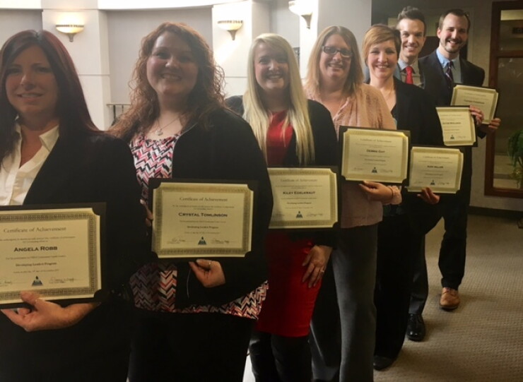 OMNI's Community CU's 2017 Developing Leaders Class proudly displays their certificates of accomplishment.