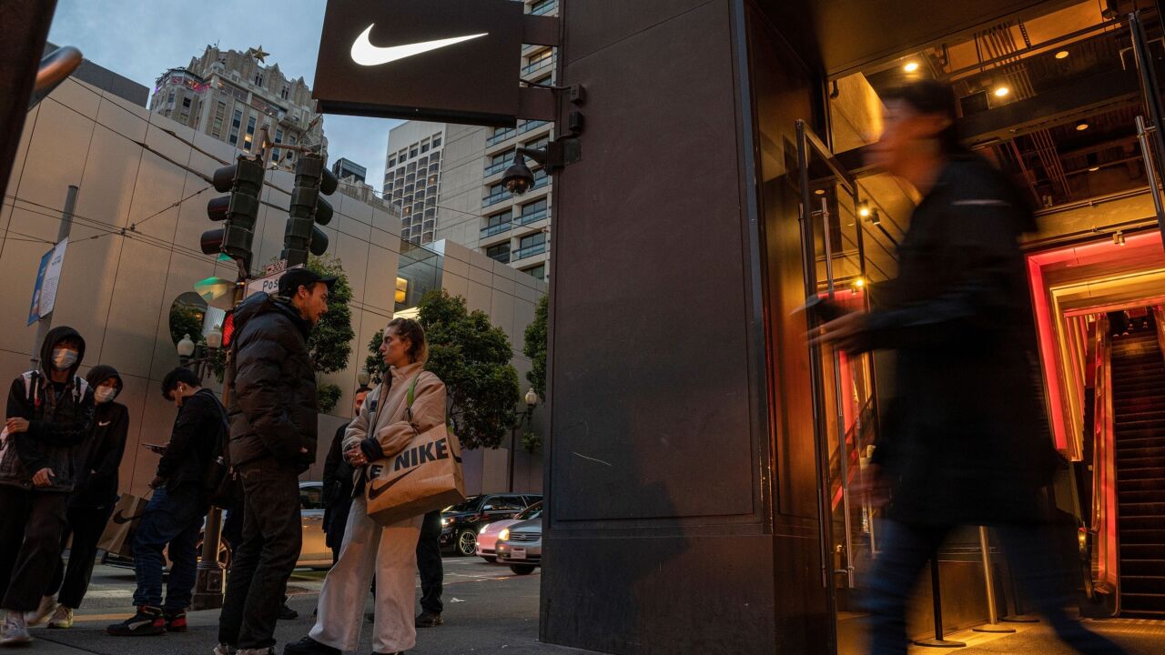 Exterior of a Nike store with the logo on the sign