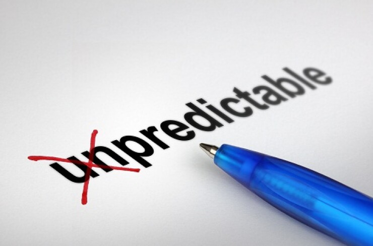 The word unpredictable with the un crossed out in red ink and blue pen pointing to the word.