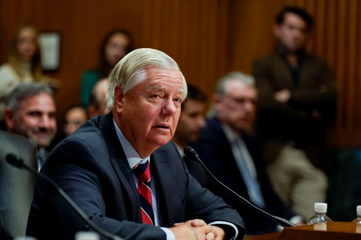 Senator Lindsey Graham sitting at a desk