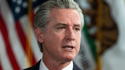 California Governor Gavin Newsom speaking with American flag in background