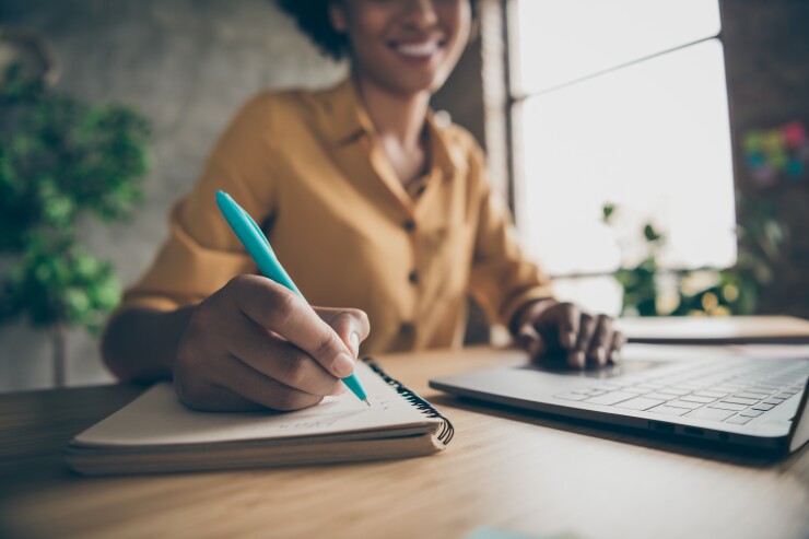 Woman making a list in notebook