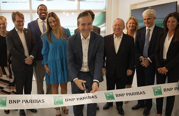BNP Paribas executives including (middle L-R) Annabella Espina, Miami office COO, Matt O’Connor, head of the new Miami office, Olivier Osty, head of global markets, José Placido, U.S. CEO along with BNP and local elected officials and leaders including Laura DiBella of FloridaCommerce, Raphaël Trapp, Consul General of France in Miami, and Rodrick Miller of the Miami-Dade Beacon Council, cut a ribbon on Wednesday to officially open the bank’s offices in the Brickell Ave area of Miami.