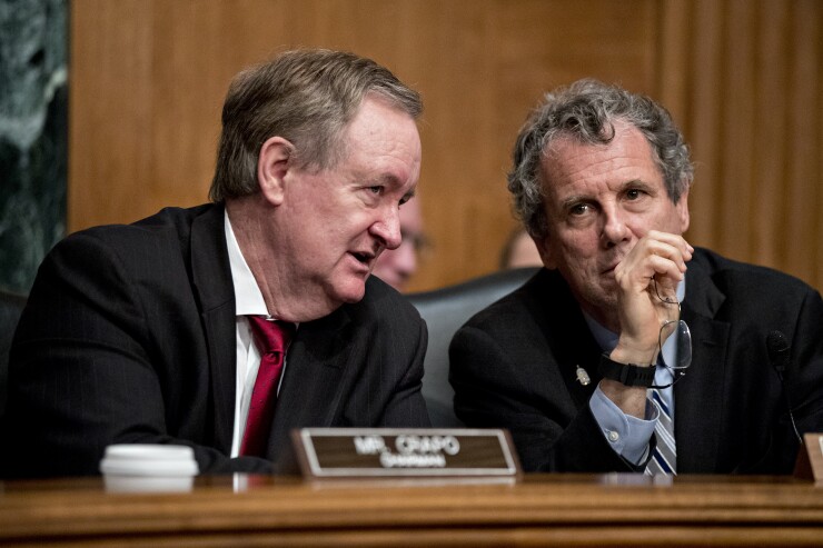 Sen. Mike Crapo (left), R-Ida., and Sen. Sherrod Brown, D-Ohio