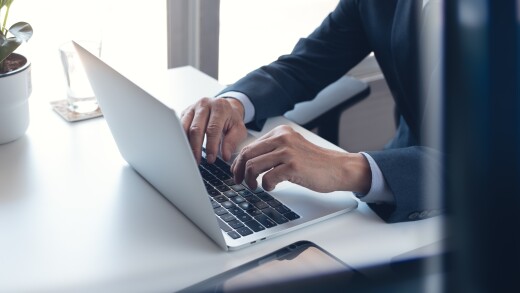 Person working on a laptop at a desk