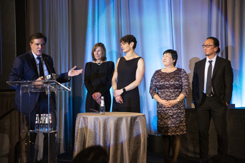 Dan Morissette of CommonSpirit Health and staff collect the Deal of the Year award