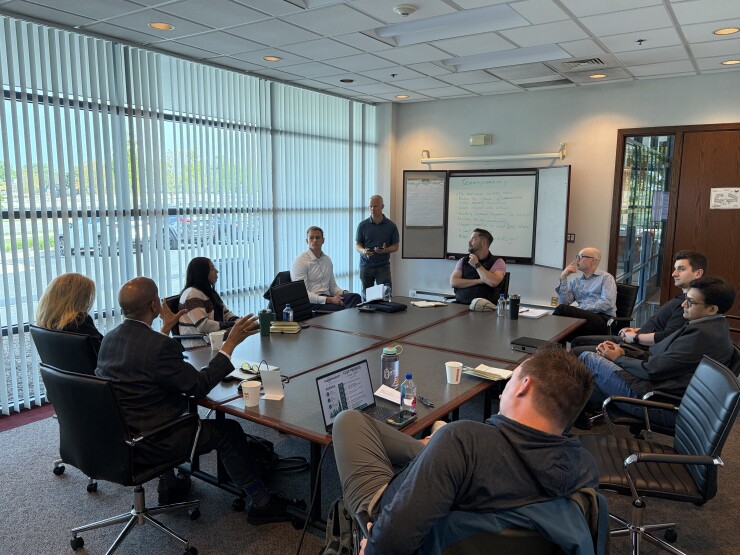 Financial planner Michael Hollis led a discussion among a dozen advisors and other professionals in the field about the meaning of transparency at a Transparent Advisor Movement "Flat Fridays" meeting last week outside Chicago.
