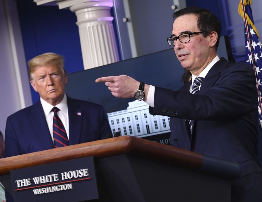 U.S. President Donald Trump, left, listens as Steven Mnuchin, U.S. Treasury secretary, speaks during a Coronavirus Task Force news conference at the White House in Washington, D.C., U.S., on Thursday, April 2