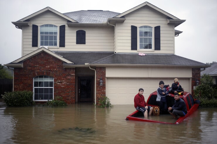 A family awaits rescue in Spring, Texas, after Hurricane Harvey's landfall in August 2017.