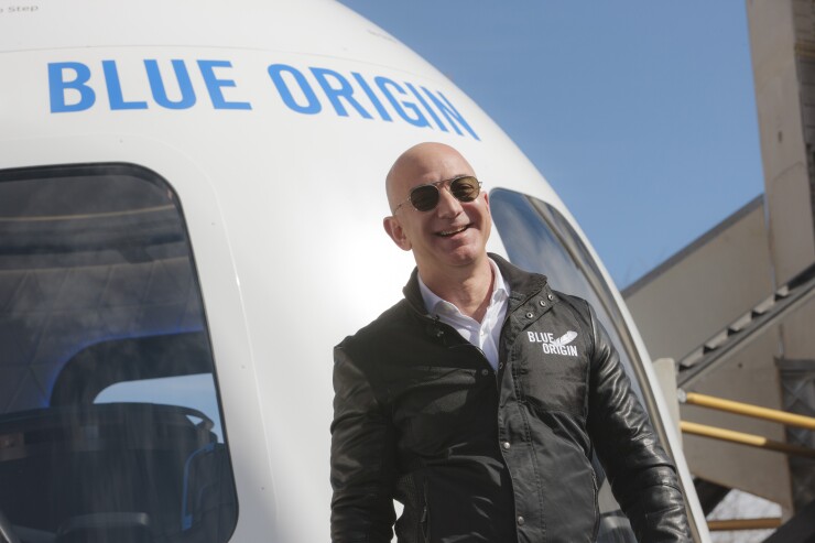 Jeff Bezos, chief executive officer of Amazon.com Inc. and founder of Blue Origin LLC, smiles while speaking at the unveiling of the Blue Origin New Shepard system during the Space Symposium in Colorado Springs, Colorado, U.S., on Wednesday, April 5, 2017.