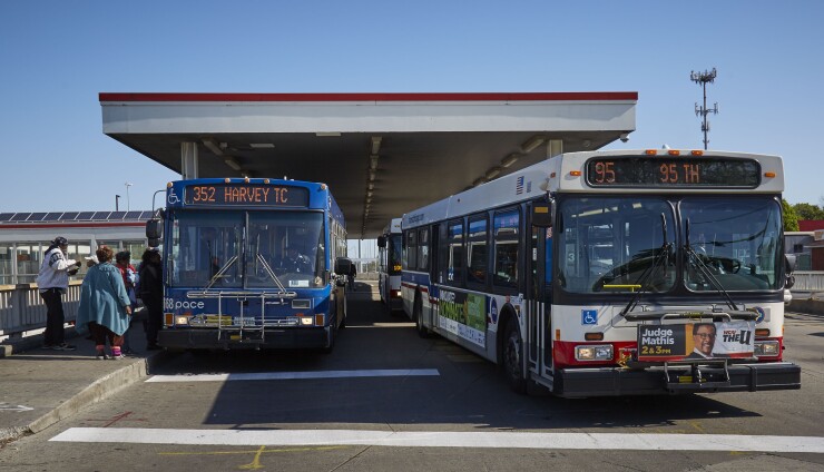 A Chicago Transit Authority bus and a PACE suburban bus.
