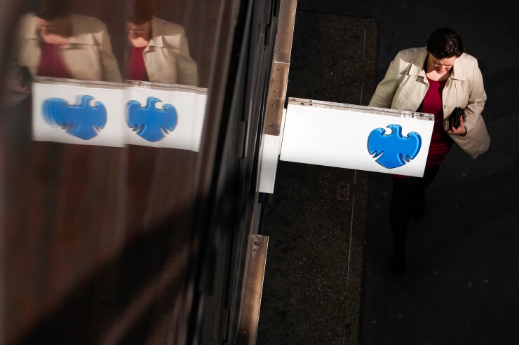 A pedestrian passes outside a Barclays bank branch in London.