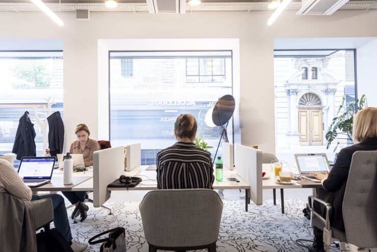 Members work on laptop computers at individual stations inside the Spaces co-working office, operated by IWG Plc, in Geneva, Switzerland, on Tuesday, Sept. 24, 2019. As investor doubts mount in the run-up to a potential initial public offering for WeWork parent We Co., shares of Swiss rival IWG have been on a tear this year, adding more than $500 million to the net worth of founder and Chief Executive Officer Mark Dixon. Photographer: Alberto Bernasconi/Bloomberg