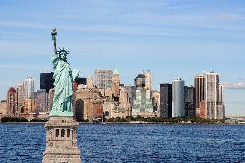 The landmark Statue of Liberty against the impressive New York City skyline.