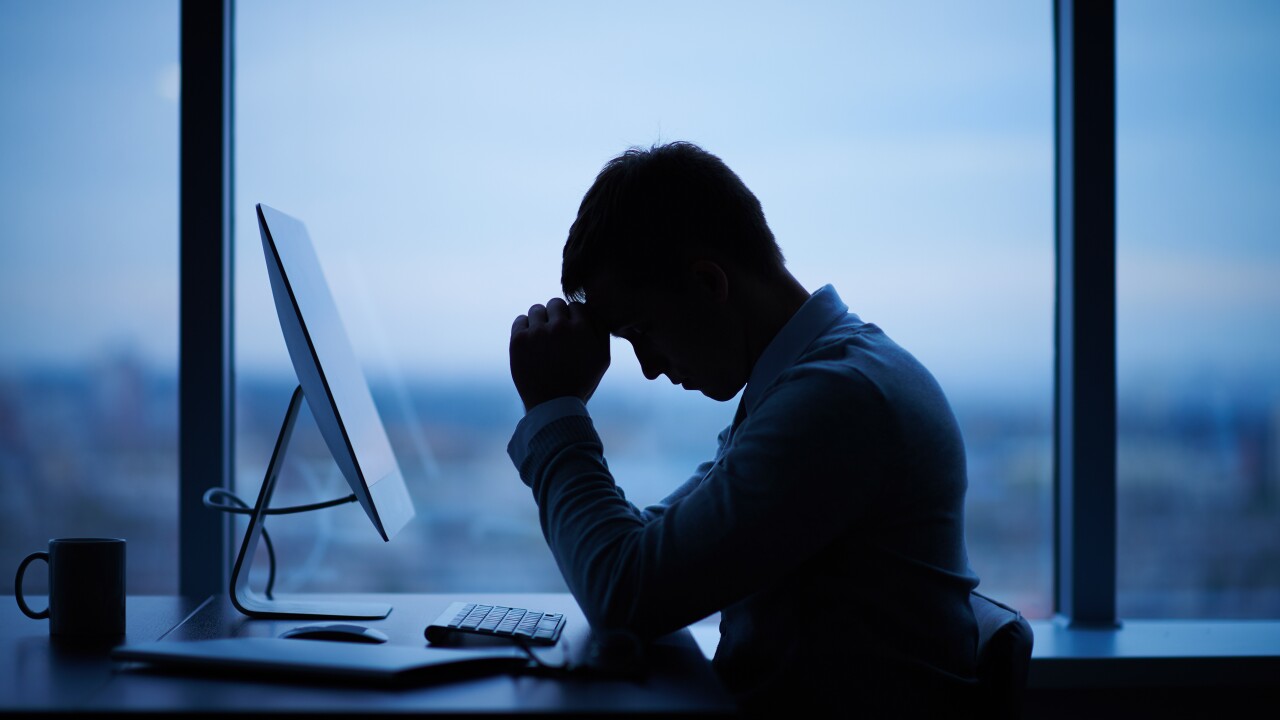 An employee working late at his desk.