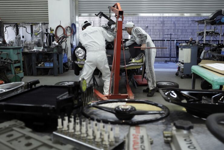 Technicians restore a classic car inside the restore pit of the History Garage exhibit at the company's Mega Web car theme park in Tokyo, Japan, on Friday, Feb. 3, 2017. Toyota is scheduled to report third-quarter earnings figures on Feb. 6. Photographer: Kiyoshi Ota/Bloomberg